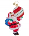 Santa has the whole holiday resting on his shoulders, carrying a sack of gifts and striped ball ornament in this elaborately handcrafted gift from Christopher Radko.