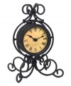 Wrought iron is elegantly twisted around this timepiece, gracing your tabletop with traditional grandeur. With an antique dial and bold Roman numerals, this clock evokes another time and place.