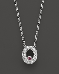 From the Tiny Treasures collection, a diamond O necklace. With signature ruby accent. Designed by Roberto Coin.