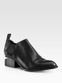 A metal cutout heel modernizes this sleek leather ankle boot with elastic panels for easy on and off access. Stacked heel with metal cutout, 1½ (40mm)Leather upper with elastic panelsPull-on styleLeather lining and solePadded insoleImported