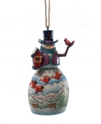 With details that recall American folk art, Jim Shore's snowman and cardinal ornament will become a beloved addition to your holiday collection.