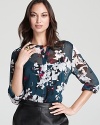 Painterly blossoms bloom from a sheer DKNY blouse for an effortlessly romantic sentiment. Slip the feminine style into a tough-girl pencil skirt for 9-to-5 glam.