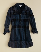 Burberry transforms a classic check sport shirt into a lovely dress, softening the silhouette with a round hem, ruffle cuffs and small spread collar.