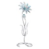 The beautiful Dellaria is made of Aurora Borealis crystal which refracts light, changing color at different angles. There is a bud and accents on the stamen in Aquamarine crystal. The flower comes with leaves on a silvertone metal stand. This large flower adds a beautiful touch to any home.