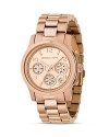 Michael Kors classic chronograph three-link bracelet watch in stainless steel. Round rose goldtone dial with Arabic numbers. Three subdials and date display.