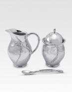 A handmade creamer and sugar set in hammered, sandcast aluminum, buffed by hand for unparalleled shine and elegance. Set includes sugar bowl with lid, creamer and matching spoon Creamer, 4½H X 3 diam. Sugar, 4½H X 3 diam. Spoon, 5 long Sandcast aluminum Food safe Hand wash Imported 