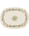 Perfect for entertaining, this large platter is trimmed with gold and a holly motif to match the beloved Lenox Holiday dinnerware collection.