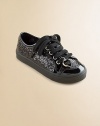 Sparkle and shine in a comfy sneaker, covered with sequins and accented with shiny patent.Faux leather and faux patent upper with sequinsLace-up front with heart charmFaux leather liningPadded insoleRubber composite soleImported