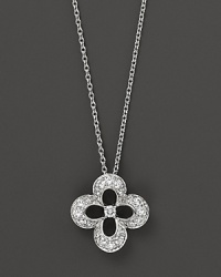 Diamonds set in a 14K. white gold flower pendant.