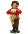 A young boy helps with the holiday shopping, picking up a traditional straw ornament and clog full of goodies in this handcrafted figurine from Byers' Choice.