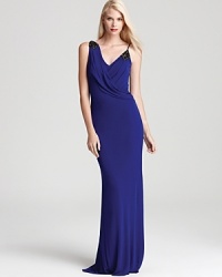 With elegant draping, Badgley Mischka's v neck gown shows off subtle beaded details for a hint of sparkle.