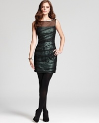 Shimmering emerald green sequins dazzle from under ruched black mesh lending instant glamour to this Cynthia Steffe dress--finished with a sheer neckline for added allure.