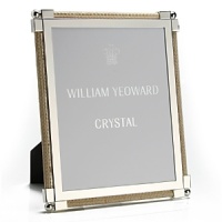 Made entirely from hand, each piece of William Yeoward Crystal draws its inspiration from antique crystal pieces originally made in England during the 18th and early 19th centuries. Traditionally styled and utterly elegant, the Classic Raffia frame is an elegant way to frame your favorite photos.