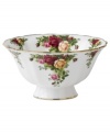 Garnished with the popular Old Country Roses dinnerware pattern, this footed Royal Albert bowl brings the bounty of the English countryside to your table in fine bone china with gold, scalloped edges.