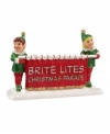 Two smiling elves take the lead in the Brite Lites Christmas parade, a favorite holiday tradition in Department 56's Snow Village.