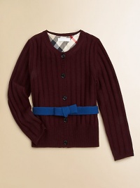 A wide ribbed texture and a contrast ribbon with a bow give this merino wool sweater its pretty panache.Round ribbed necklineLong sleeves with ribbed cuffsContrast attached self beltButton placketWide ribbed hemMerino woolDry cleanImported Please note: Number of buttons may vary depending on size ordered. 