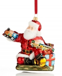 Santa takes great care to test-drive all the toys in his workshop, playing the role of conductor in this merrymaking ornament, handcrafted of Polonaise glass. By Kurt Adler.