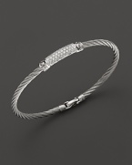 Diamonds, white gold and stainless steel on a modern, elegant bangle. By Charriol.