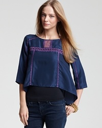 The season's latest crop arrives with this BCBGMAXAZRIA silk top, adorned with detailed embroidery and triangular cut-outs. Layer over a basic tank and team with jeans for off-duty boho-chic.