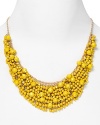 Brighten up every outfit with this layered beaded bib necklace from Cara accented by a dramatic collar of yellow stones.