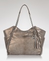 A haute bohemian tote from MICHAEL Michael Kors with gleaming hardware and decorative tassel detail.