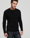 A Victorinox crewneck sweater features shoulder and elbow patches, reinforcing a refined military-inspired look.