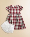 Adorned with a festive plaid print and matching tie, this gorgeous cotton frock with matching bloomers will make your little girl feel like a sugarplum fairy.Peter Pan collarShort puff sleevesBack buttonsWaistband with ribbon tieFull skirtFully linedCottonDry cleanImported Please note: Number of buttons may vary depending on size ordered. 