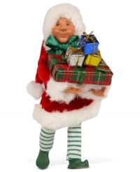 Wrap it up! He has his hands full, but Santa's little helper is filled with glee as he wraps an endless pile of Christmas presents. An adorable figurine with the unmistakable style of Byers' Choice.