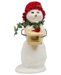 Something for on and under the tree, this thoughtful snowman brings a new house for her feathered friend. With a holiday-red bonnet and holly scarf by Byers' Choice.