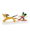 Mush mush, woof woof. Mickey Mouse catches some air on his snowboard as lovable Pluto races through the snow in this adorable Mickey's Village figurine from Department 56.