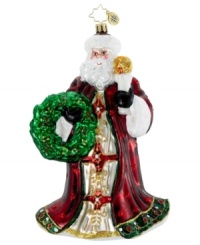 Santa Claus illuminates the holiday with a single candle and his dazzling coat of burgundy, gold and green in this handcrafted ornament by Christopher Radko.