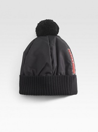 Nylon and wool puffer hat with pom pom detail.Ribbed hemNylon/woolDry cleanMade in Italy