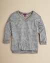 A sparkly metallic top in a fun, honeycomb patterned knit-layer over a bright tee for an extra pop of color.