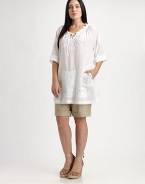 Thanks to its chic, roll-tab sleeves and relaxed fit, this cotton design offers a flattering, ultra-feminine fit. Plus, you will not be able to resist its gorgeous embroidery.Self-tie detail at ruched necklineRoll-tab sleevesLovely embellished detailsPull-on styleAbout 34 from shoulder to hemCottonDry cleanImported