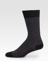 A stylish combination of jacquard and houndstooth adds charming appeal to these wool socks with a touch of stretch.Mid-calf height80% virgin wool/20% polyamideMachine washMade in Italy