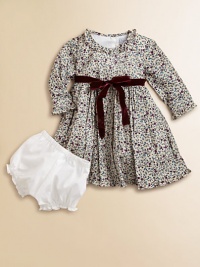 Blooming with a vivid floral print and a velvet tie, this delightful cotton frock with matching bloomers will make your little one feel like a flower girl.Ruffled round necklineLong sleevesBack buttonsWaistband with velvet ribbon tieFull skirtFully linedCottonMachine washImported Please note: Number of buttons may vary depending on size ordered. 