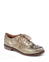 Must-have oxford flats are golden in snakeskin-embossed metallic leather that takes the look from library to Las Vegas, by Lucky Brand.