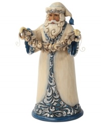 Santa shimmers & shines. Dressing up in brilliant blue & silver hues, Santa takes a moment to decorate your home with a string of festive garland.