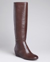 Sleekly chic, these Boutique 9 boots are ready for work or play, on wearable low wedges. Look-and feel-good.