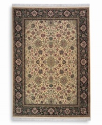 Inspired by the easily recognizable and intricately beautiful textiles of the Kirman region of ancient Persia, this Indo-Kirman rug features graceful floral designs in a rich palette of individually-dyed colors including indigo, soft blues, peach-corals, golds, lavender, and a multitude of soft greens. Patterned on an antique carpet woven circa 1910, it has a soft luster-wash that imparts a soft vintage finish.