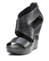 Modern leather wood wedge sandals with thick criss-crossing straps.