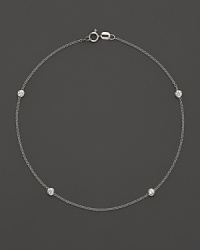 Diamond bezels sparkle from the stations on this dainty 14K white gold ankle bracelet.