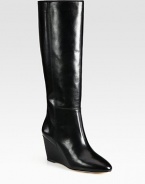 With intricate stitching and a glossy finish, this leather knee-high design has a towering wedge and padded insole. Self-covered wedge, 3 (75mm)Shaft, 15½Leg circumference, 14Leather upperLeather lining and solePadded insoleImported