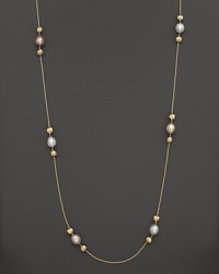 White and peach pearls create gleaming contrast with textured 18K yellow gold beads. From the Africa Pearl Collection.