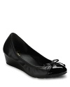 A sweet, slim bow trims these captoe wedges, the perfect marriage of comfort and chic. By Cole Haan.