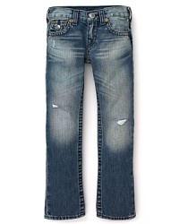 Slim-cut distressed jeans with ripped details translate to tough True Religion denim.