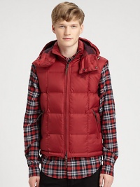 A warm, quilted silhouette and a removable drawstring hood adds a city-cool look to this military-inspired down vest for a relaxed, refined style that will remain season after season.Two-way frontRemovable drawstring hoodSide zip pocketsAbout 26 from shoulder to hemNylonDry cleanImported