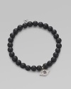 A protective symbol in many cultures, an evil eye charm of 14k white gold is richly set with diamonds and sapphires, and hangs from a stretchy strand of matte black onyx beads. Diamonds, 0.07 tcw Black onyx 14k white gold Diameter, about 2 (unstretched) Charm length, about ½ Imported