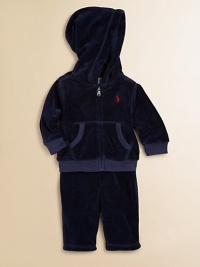 This coordinating athletic set includes a classic full-zip hoodie and a matching sweatpant in soft, cozy velour. Hoodie Attached hoodLong sleevesFull-zip frontSplit kangaroo pocketRibbed cuffs and hem Sweatpants Elasticized waist with tieMock fly87% cotton/13% polyesterMachine washImported