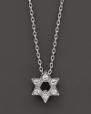 From the Tiny Treasures collection, a Star of David necklace makes a religious statement; with signature ruby accent. Designed by Roberto Coin.